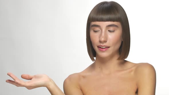 Lovely Girl with Naked Shoulders Holding Arm for Copy Space alt