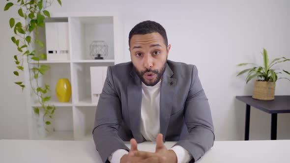 Webcam View of a Video Conference of a Latin Businessman Looking at a Serious Camera alt