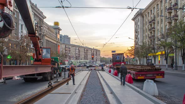 Orange Construction Telescopic Mobile Crane Unloading Tram Rails From Truck Timelapse alt