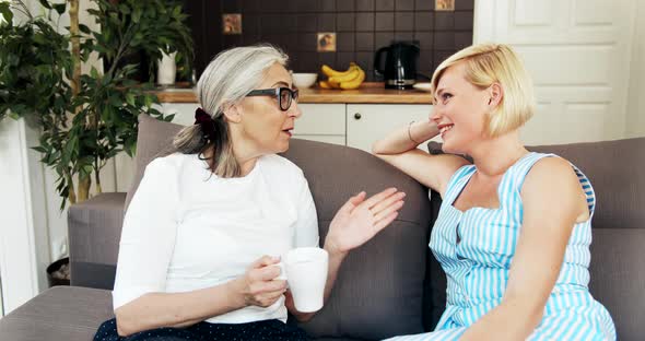 Mother and Daughter Talking on Sofa