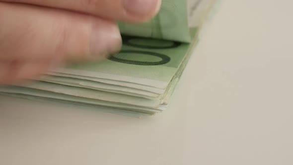 Counting Euros by hand on white surface 1080p FullHD footage - Slow motion of European Union currenc alt