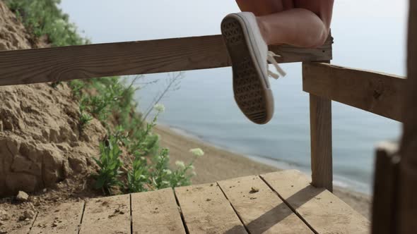 Unkwown Girl Legs White Sneakers Having Fun on Seashore Staircase Close Up alt