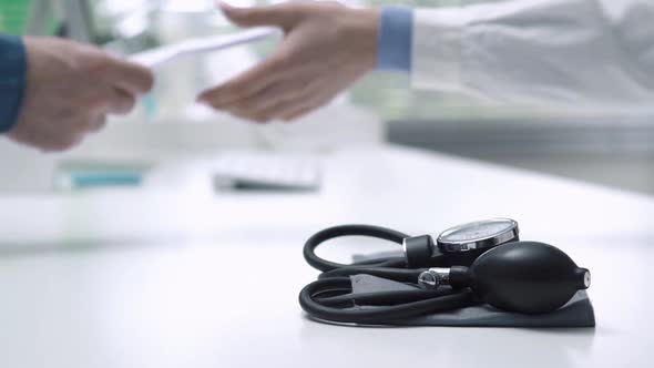 Doctor giving a prescription for hypertension