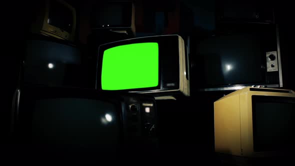 Retro Television Set with Green Screen Between Many Retro TVs. Zoom In. 4K Version.