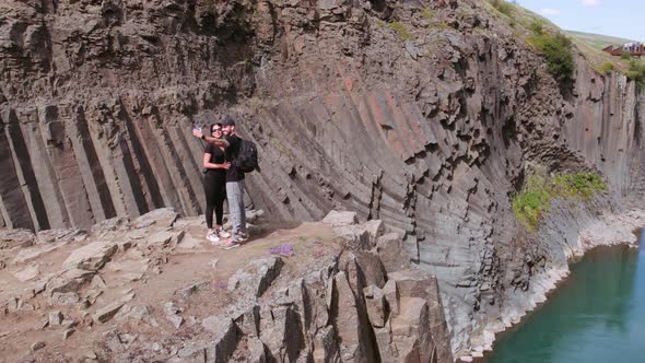 Tourists Taking Selfie Along Studlagil Canyon on a Sunny Day alt