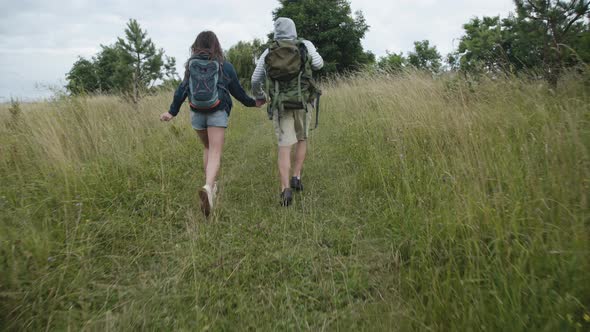 Happy Couple in Love Walking on Nature and Twisting.  alt