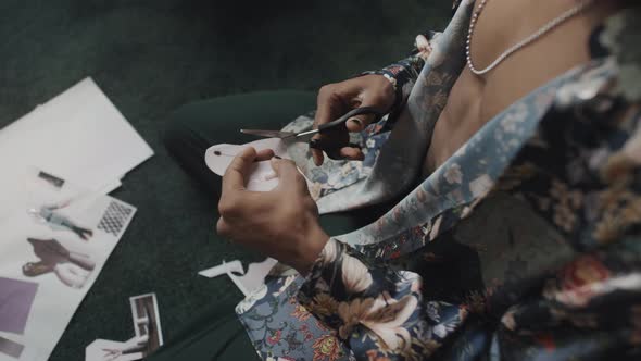 Male Fashion Designer Cutting Pictures for Mood Board alt