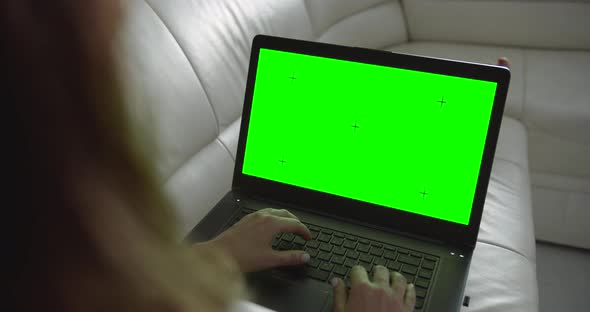 Woman with Laptop Chromakey on Sofa