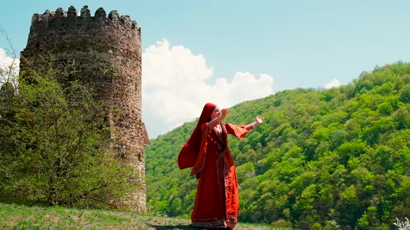 A Girl in a National Georgian Red Dress is Dancing alt