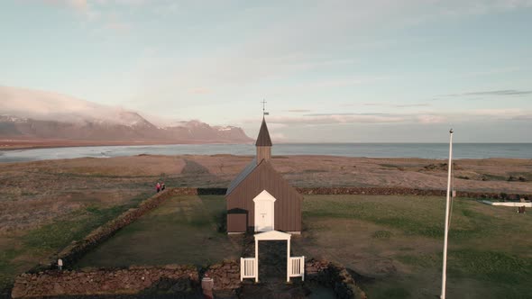 Tight aerial parallax around Black Church of Budir, Snaefellsness, Iceland. alt