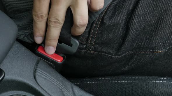 Unlocking of 3-point seat belt in modern car slow motion footage