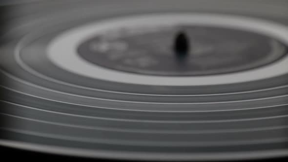 Fragment of a rotating black vinyl record player