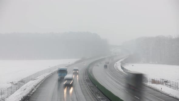 Traffic On Highway During Foggy Winter Day