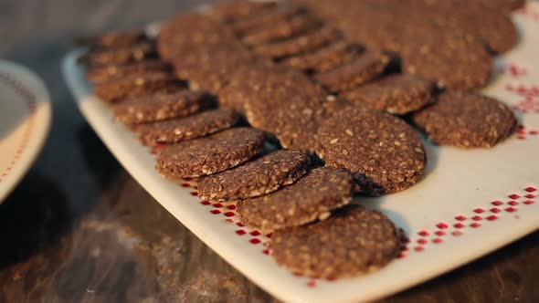 Homemade Oatmeal Cookies With Sesame Seeds On a White Plate With Ornament