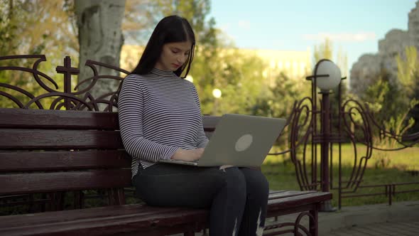 Busy Girl Working at Laptop in City Park on Summer Outdoor Shot in Urban Area