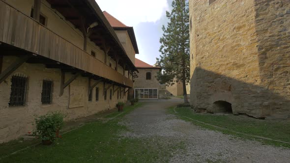 A path by a medieval building inside a fortress alt