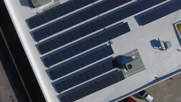 Solar panels on the roof of modern factory industrial warehouse. Clean renewable electrical energy alt