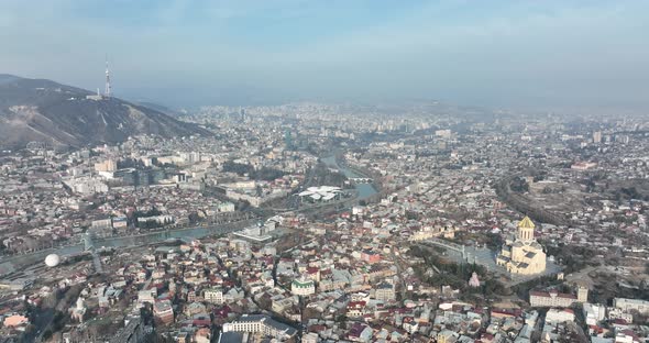 Aerial view of Holy Trinity Cathedral Sameba in Tbilisi Georgia. Sunrise drone footage. alt