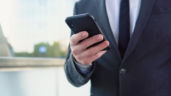 Businessman Talking Mobile Phone Near Modern Office Building alt