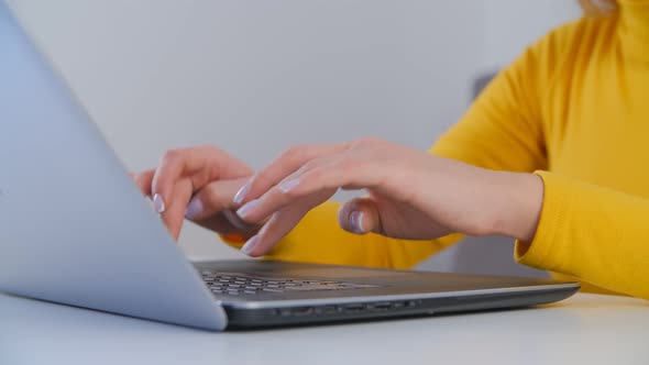 Freelancer woman typing on notebook computer keyboard in closeup 4k footage alt