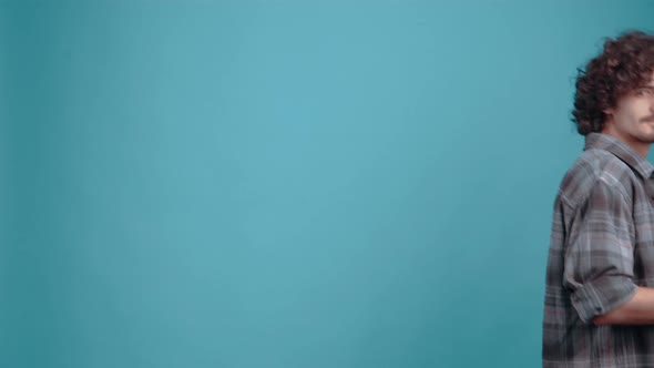 The Charismatic Young Man Appears on the Blue Background Walking Backwards with 4 Glasses of Coffee alt