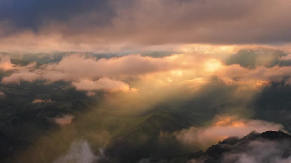 Low Clouds Over a Highland Plateau in the Rays of Sunset alt