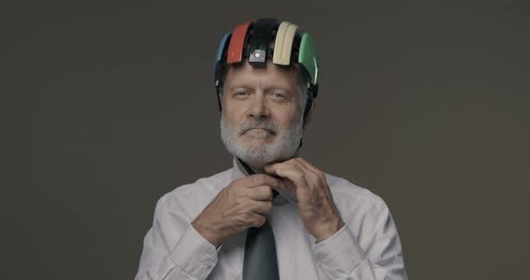 Senior businessman wearing a cycling helmet, safe business and protection concept