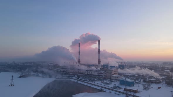 Industrial zone with pipe thick white smoke from the factory chimney at winter alt
