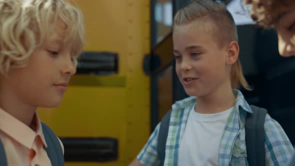 Three Teen Children Standing at Open Bus Door Closeup alt