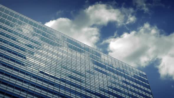 Large Modern Building Reflecting Clouds alt