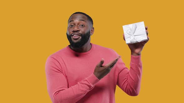 Excited Young African American Man Guy in Pink Isolated on Yellow Background alt