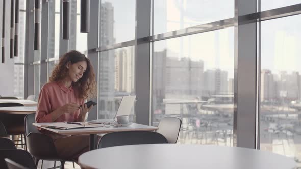 Attractive Businesswoman Answering Cellphone Call alt