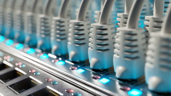 Countless white ethernet cables in a  server cabinet lit by a single spotlight. alt