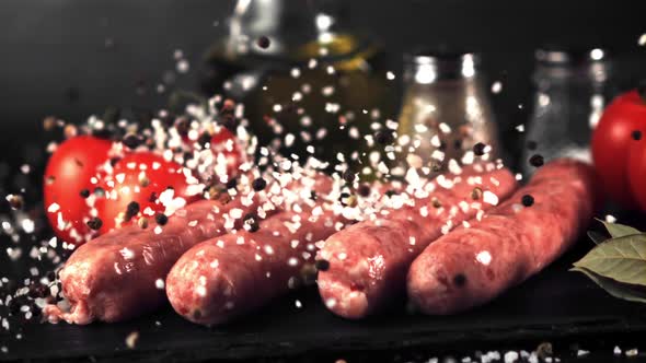 Super Slow Motion on the Raw Sausage Drops Salt and Pepper alt