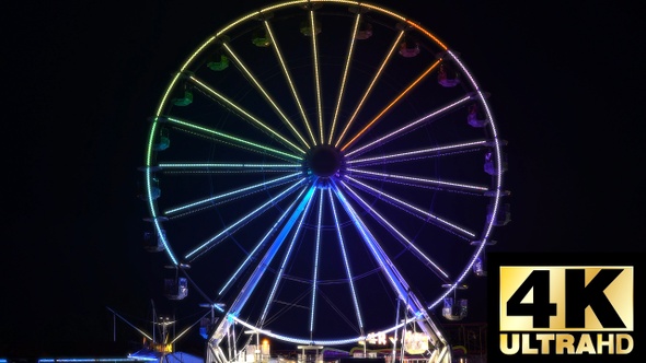 Timelapse of Luminous colorful ferris wheel in luna park. Amusement park at night in 4K