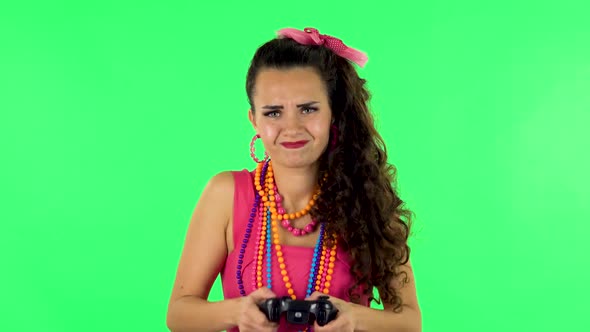 Girl Playing a Video Game Using a Wireless Controller and Loses. Green Screen alt