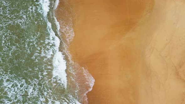 Aerial view of white sand beach and ocean wave alt