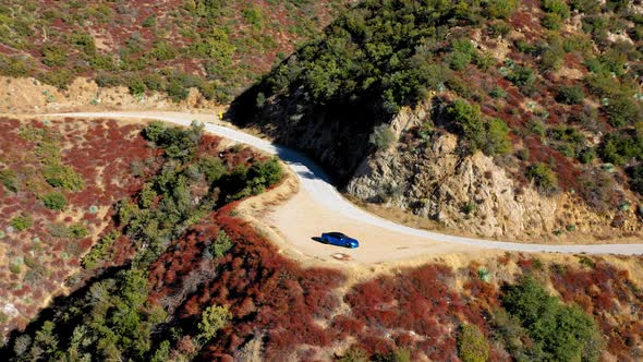 Panning left shot of a blue Tesla Model S on Mt. Baldy in Southern California. alt