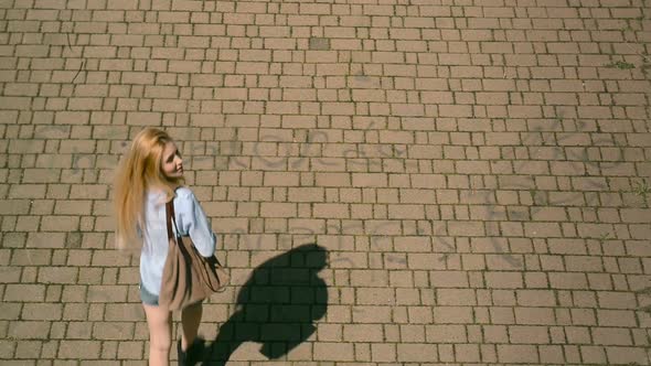 Overhead Top View of Young Beautiful Blonde Girl in Summer Day Walks in Urban City