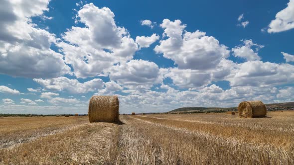 Field With Bales Of Hay And Beautiful Sky Time Lapse