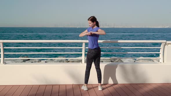 Girl Does Exercises Near Sea