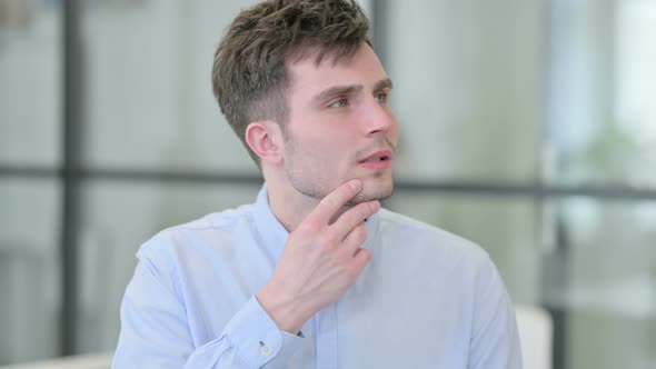 Portrait of Pensive Young Man Thinking alt