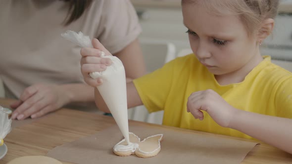 A Child in the Kitchen Helps Mom