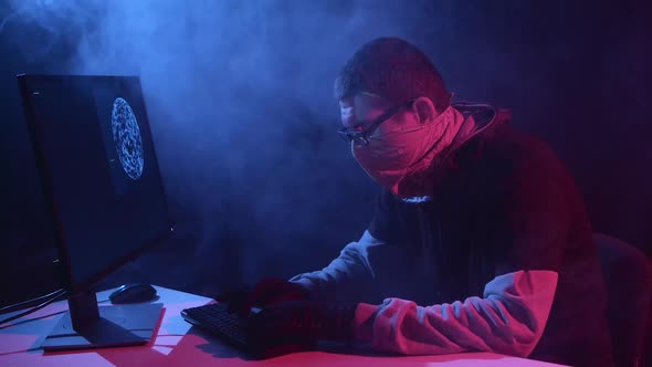 Spy Enters Virus Data Into the Computer. Black Smoke Background alt