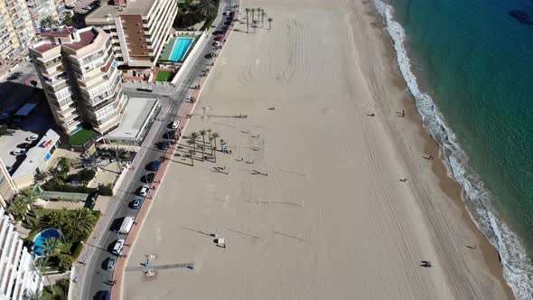 Aerial footage of Benidorm beach known as Playa Levante beach, hotels, buildings and restaurants