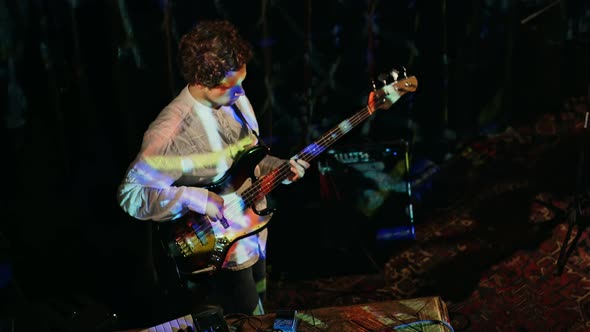 View From Above on Musician Playing Bass Guitar in the Club alt