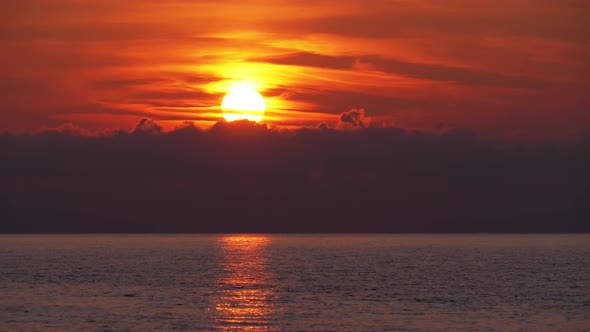 Sunset in the Clouds Over the Sea. Orange Path Sunset in the Sea alt