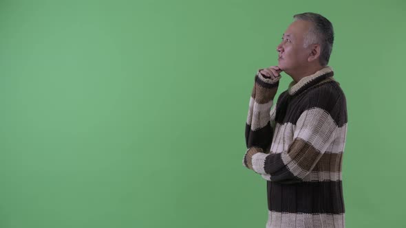 Profile View of Happy Mature Japanese Man Thinking Ready for Winter alt