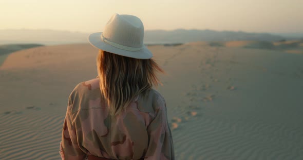 Slow Motion Woman Enjoying Golden Sunset Over Ocean, Walking By the Sand Dunes alt