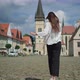 Tourist Woman is Running Over Town Hall Square in Bardejov in Slovakia